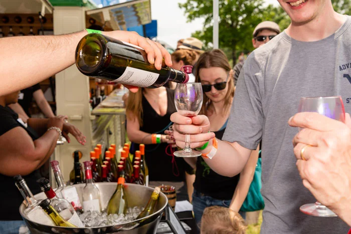 Wine being poured for guests at a festival tasting